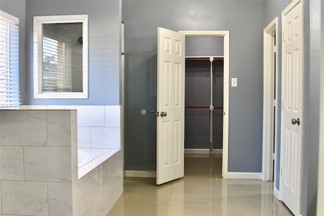 bathroom featuring tile patterned flooring and independent shower and bath