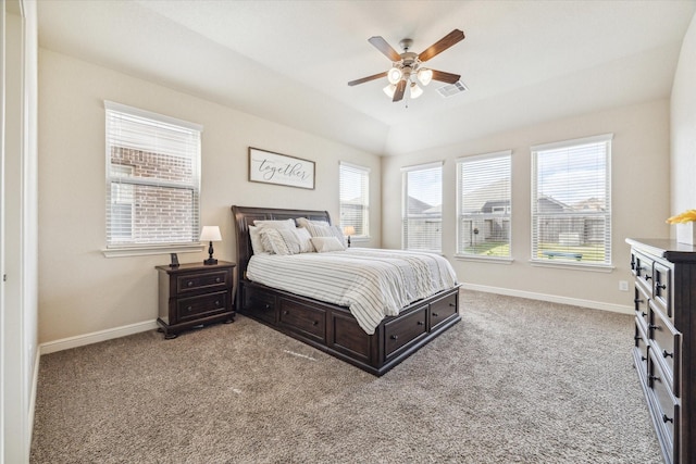 carpeted bedroom featuring multiple windows, ceiling fan, and lofted ceiling