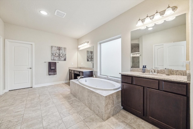 bathroom with shower with separate bathtub, vanity, and tile patterned floors