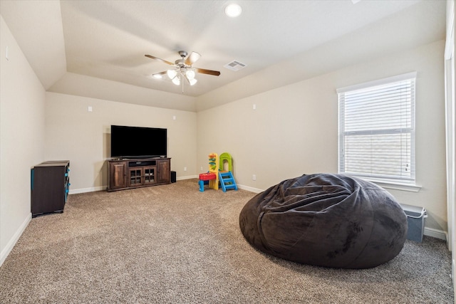 game room with a tray ceiling, ceiling fan, and carpet flooring