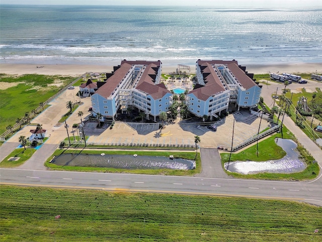 bird's eye view featuring a water view and a view of the beach