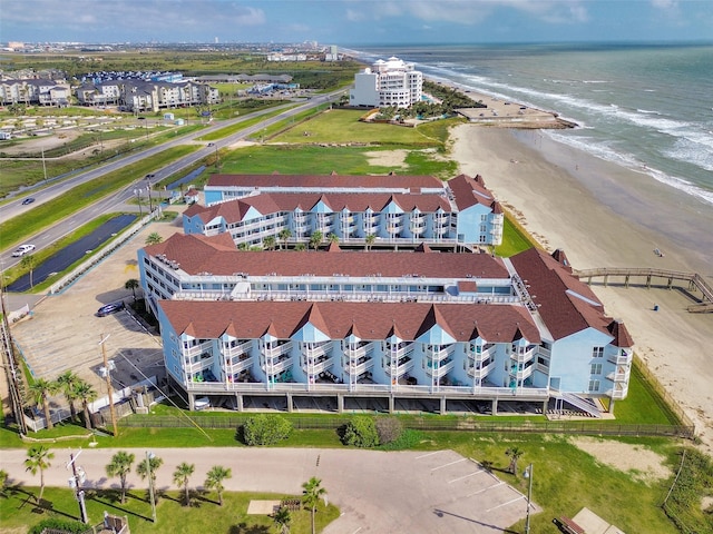 birds eye view of property featuring a beach view and a water view