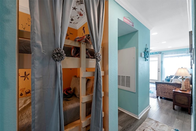 corridor with hardwood / wood-style flooring and crown molding