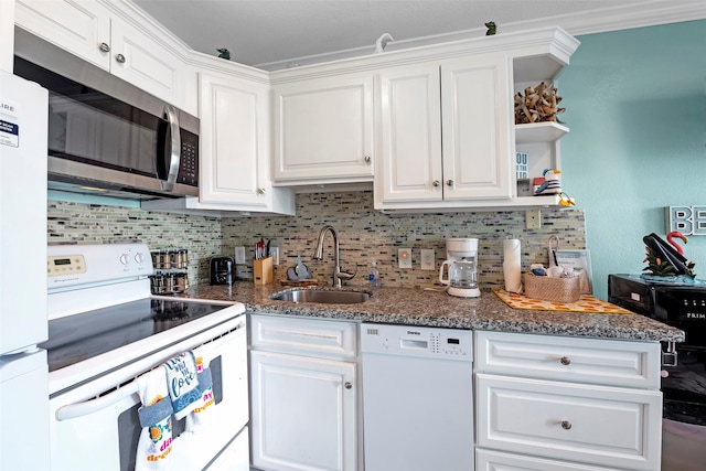 kitchen with white cabinets, white appliances, dark stone counters, and sink