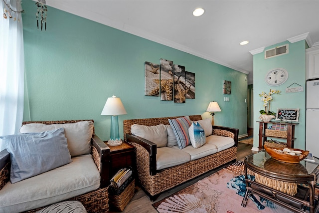 living room with hardwood / wood-style flooring and ornamental molding