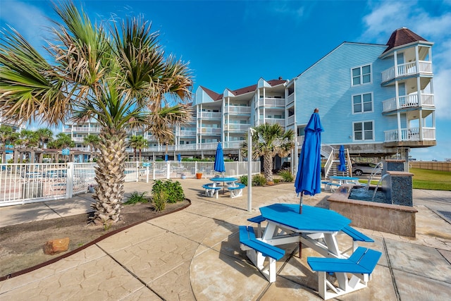 view of community with a swimming pool and a patio