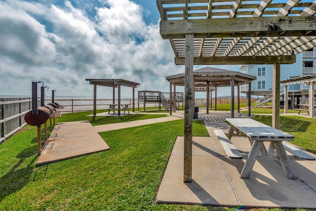 exterior space featuring a pergola and a lawn