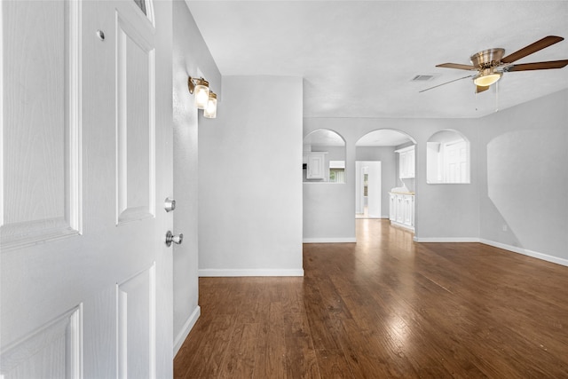 unfurnished room with ceiling fan and dark hardwood / wood-style flooring