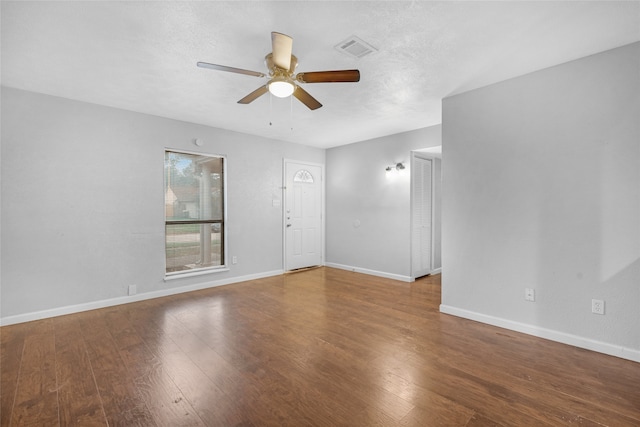 spare room featuring a textured ceiling, hardwood / wood-style flooring, and ceiling fan