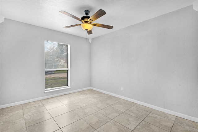 spare room with light tile patterned floors and ceiling fan