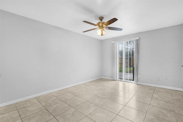 tiled spare room with ceiling fan