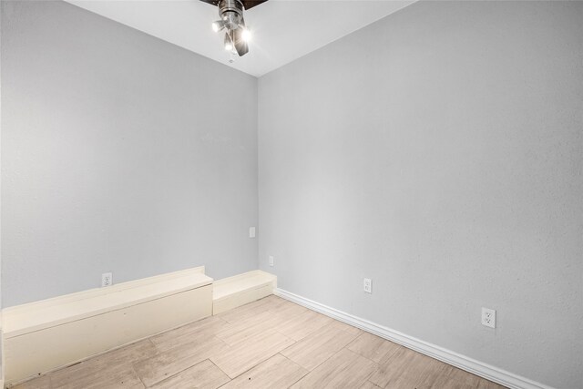 empty room with light wood-type flooring and ceiling fan