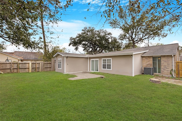 back of property featuring a patio and a yard