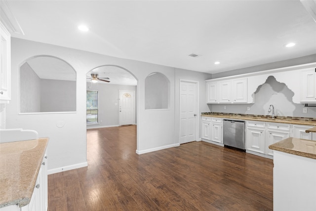 kitchen featuring white cabinetry, dark hardwood / wood-style floors, light stone countertops, sink, and stainless steel dishwasher