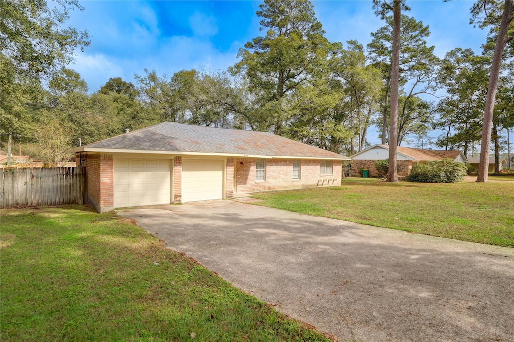 ranch-style house with a garage and a front yard