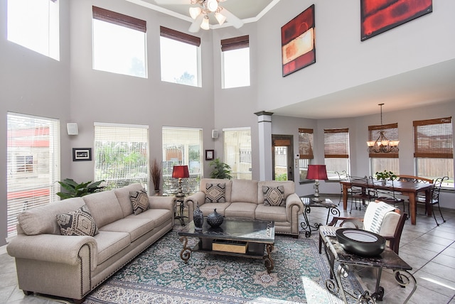 living room featuring a towering ceiling, plenty of natural light, and light tile patterned floors