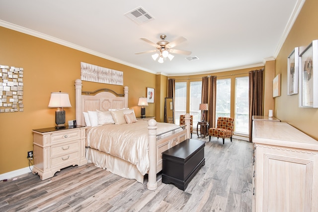 bedroom with ornamental molding, light wood-type flooring, and ceiling fan