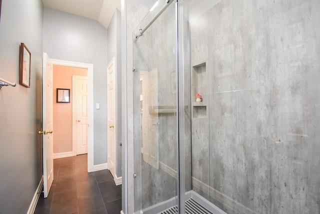 bathroom featuring walk in shower, tile patterned flooring, and vaulted ceiling