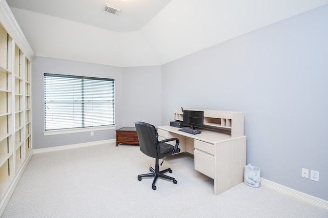 home office with light carpet and vaulted ceiling