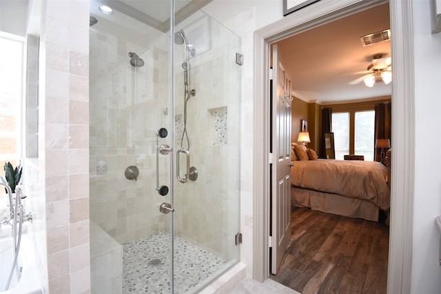 bathroom featuring hardwood / wood-style floors, ceiling fan, and a shower with shower door