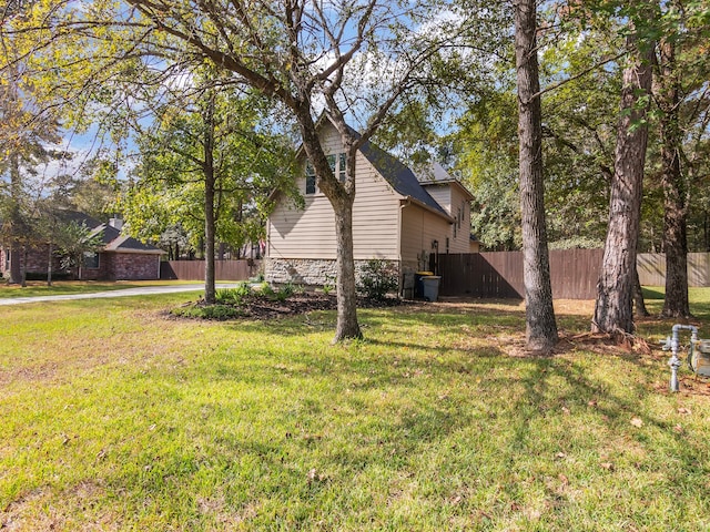 view of side of home featuring a yard