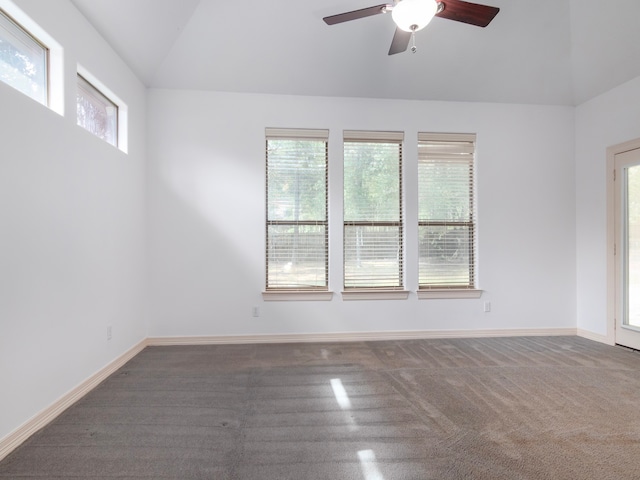 carpeted empty room with ceiling fan, lofted ceiling, and a healthy amount of sunlight