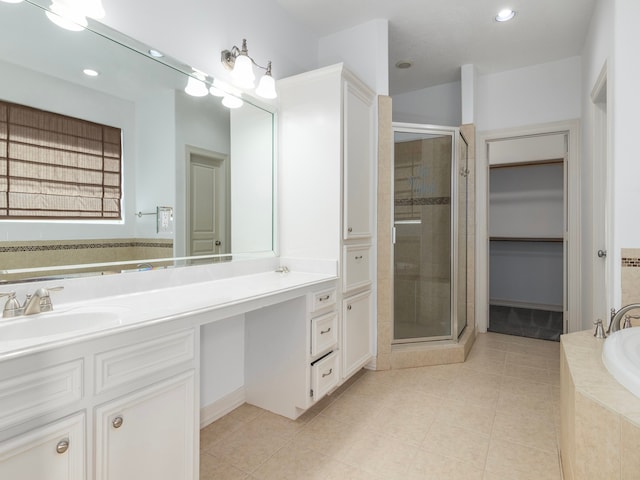 bathroom featuring tile patterned floors, vanity, and shower with separate bathtub