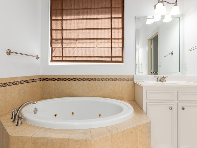 bathroom with tiled bath and vanity