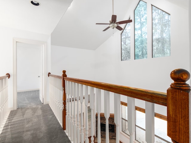 corridor with lofted ceiling and carpet floors