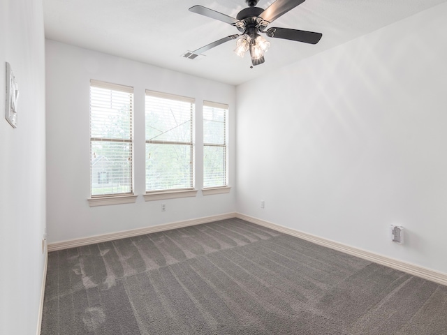 carpeted spare room featuring ceiling fan