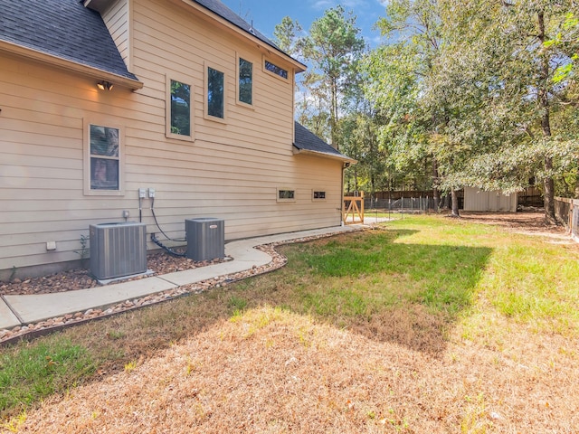 exterior space featuring cooling unit and a yard