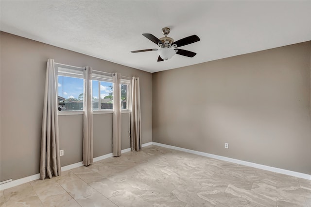 empty room featuring a textured ceiling and ceiling fan