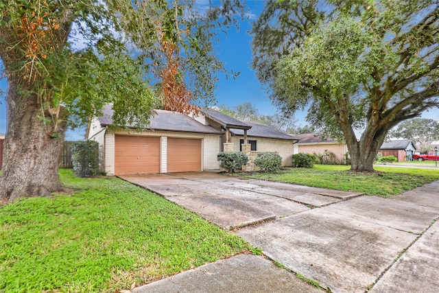 ranch-style house featuring a garage and a front yard