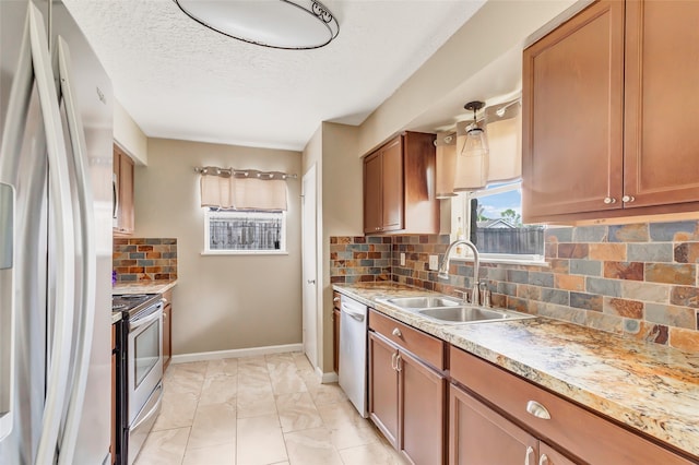 kitchen with stainless steel appliances, a textured ceiling, sink, and backsplash