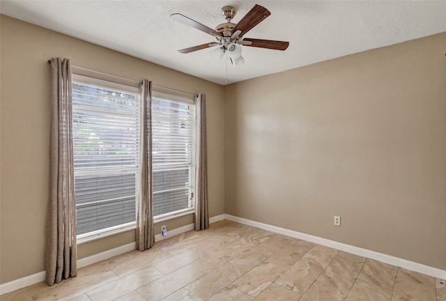 empty room with a textured ceiling and ceiling fan