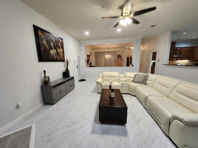 living room featuring ceiling fan with notable chandelier