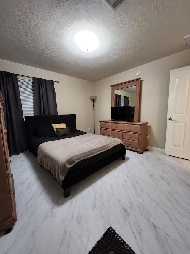 bedroom featuring a textured ceiling