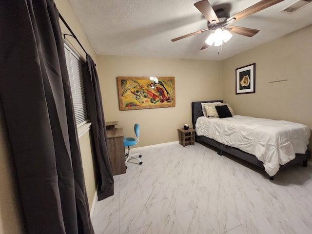 bedroom with a textured ceiling and ceiling fan