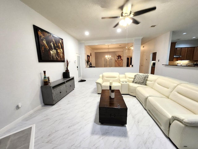 living room with ceiling fan with notable chandelier and a textured ceiling