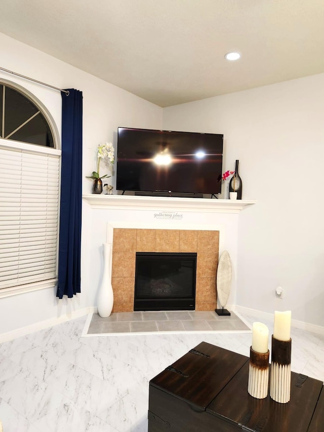 living room featuring a tiled fireplace