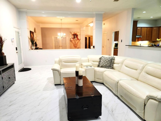 living room featuring ornamental molding and a notable chandelier