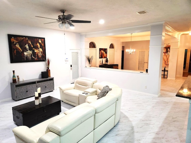 living room with ceiling fan with notable chandelier and a textured ceiling