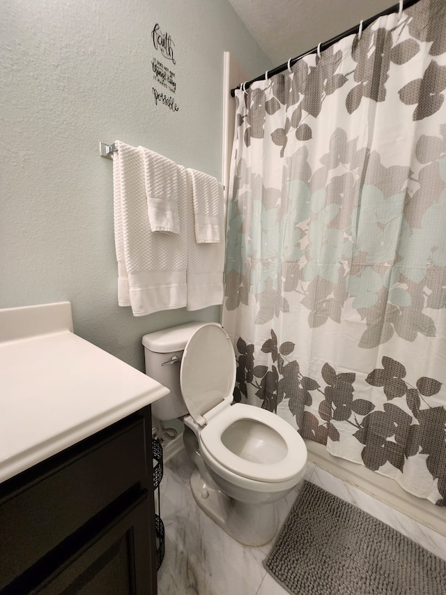 bathroom with curtained shower and toilet