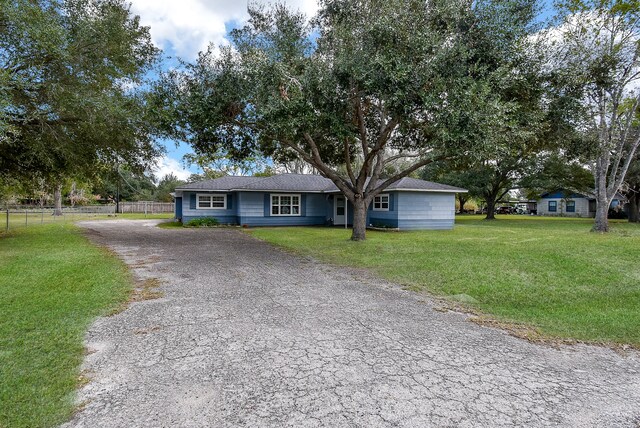 ranch-style home featuring a front yard