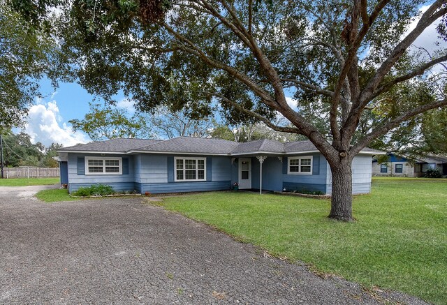 ranch-style house with a front lawn