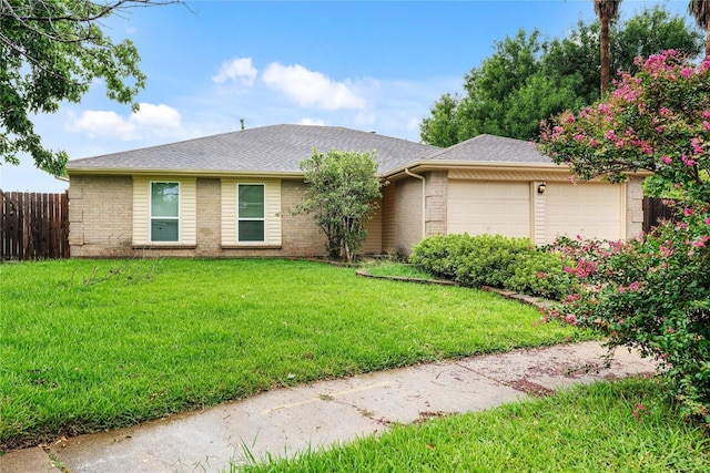 ranch-style home with a garage and a front yard