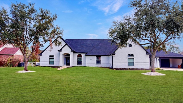 french country inspired facade with brick siding, central AC unit, a shingled roof, and a front lawn