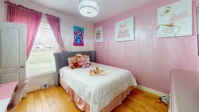 bedroom with wood-type flooring