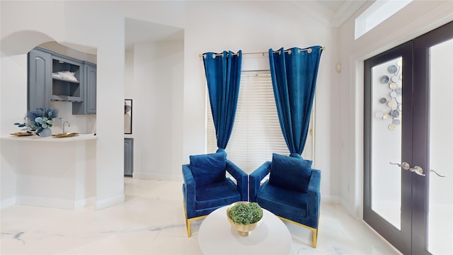 living area with french doors and ornamental molding