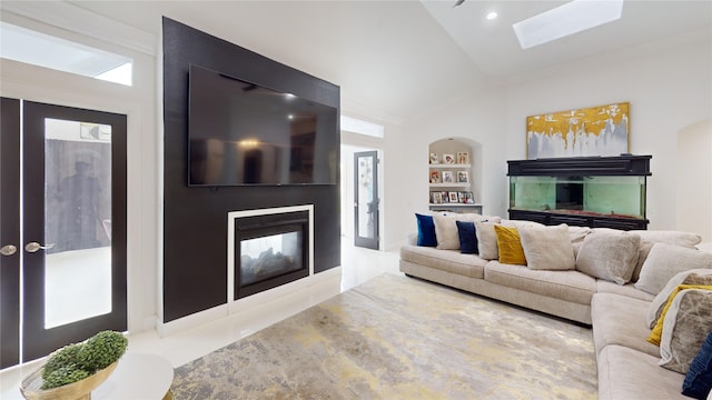 4009 Ravencrest Ct, Pearland, TX 77584 - living room with a multi sided fireplace, vaulted ceiling, ornamental molding, a skylight, and built in shelves
